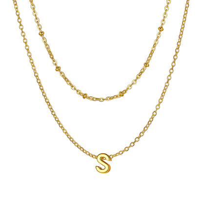 Gold Layered initial S necklace on a white background