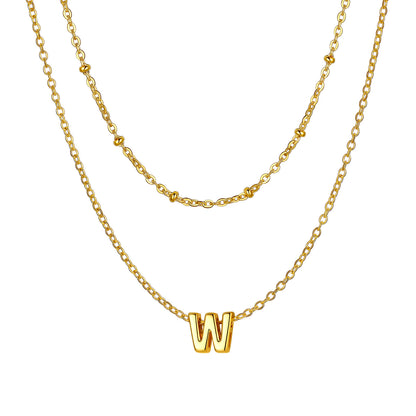 Gold Layered initial W necklace on a white background