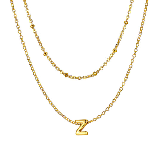Gold Z Layered initial W necklace on a white background