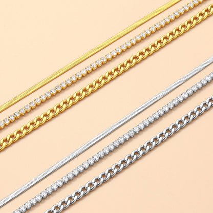Gold and silver chain ankle bracelet on a beige background