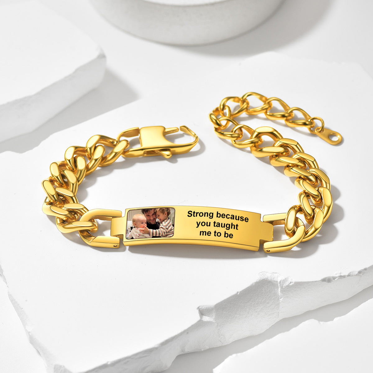 Gold chain photo bracelet with engraved message and photo on a white background