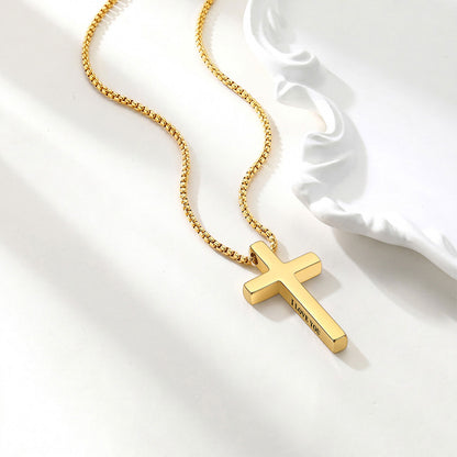 Gold cross necklace on a white background