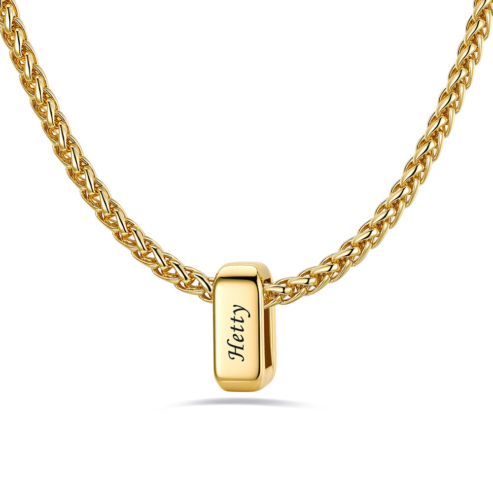Gold custom name necklace with 1 rectangular pendant engraved on a white background