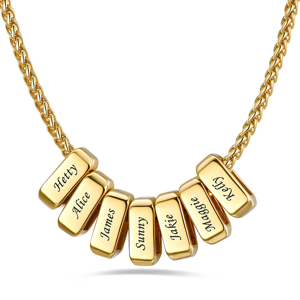 Gold custom name necklace with 7 rectangular pendant engraved on a white background