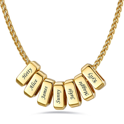 Gold custom name necklace with 7 rectangular pendant engraved on a white background