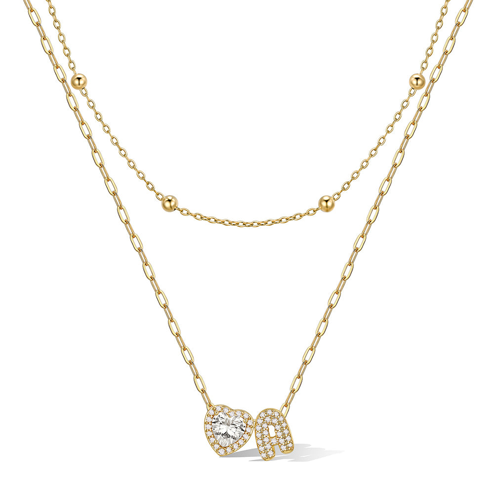 Gold cz bubble initial A necklace with a heart-shaped pendant on a white background