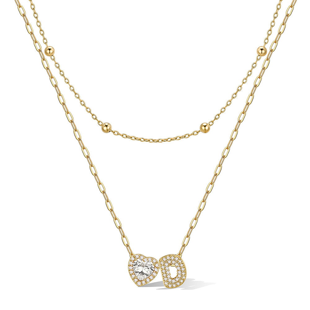 Gold cz bubble initial D necklace with a heart-shaped pendant on a white background