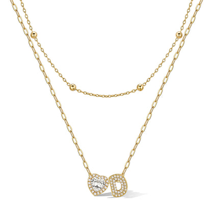 Gold cz bubble initial D necklace with a heart-shaped pendant on a white background