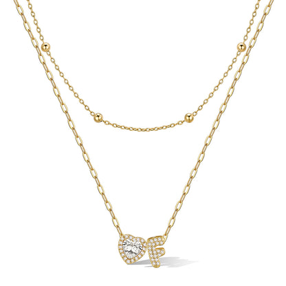 Gold cz bubble initial F necklace with a heart-shaped pendant on a white background