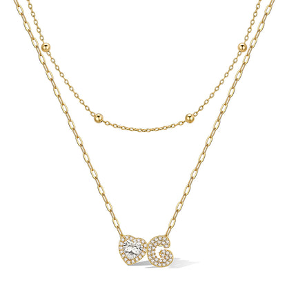 Gold cz bubble initial G necklace with a heart-shaped pendant on a white background