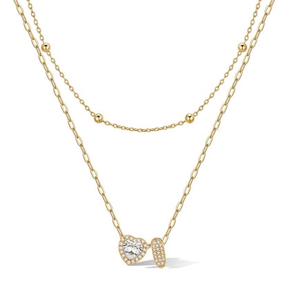 Gold cz bubble initial I necklace with a heart-shaped pendant on a white background