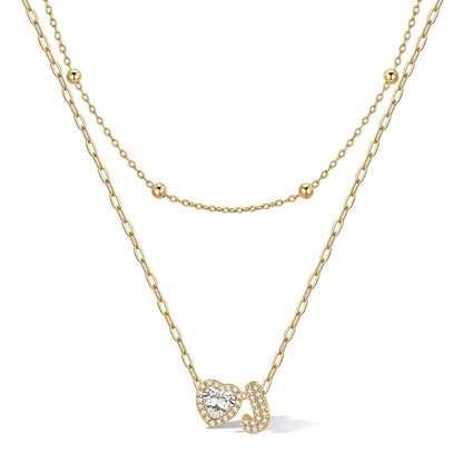 Gold cz bubble initial J necklace with a heart-shaped pendant on a white background
