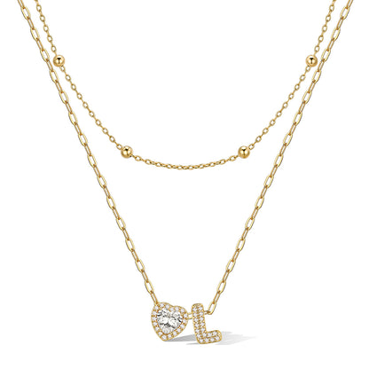 Gold cz bubble initial L necklace with a heart-shaped pendant on a white background