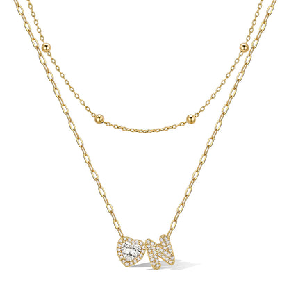 Gold cz bubble initial N necklace with a heart-shaped pendant on a white background