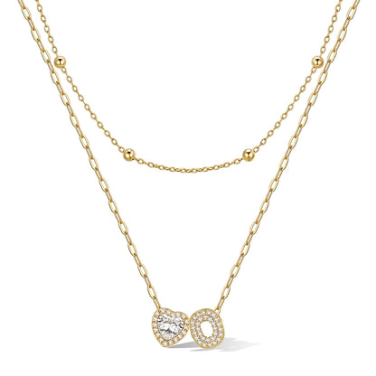 Gold cz bubble initial O necklace with a heart-shaped pendant on a white background