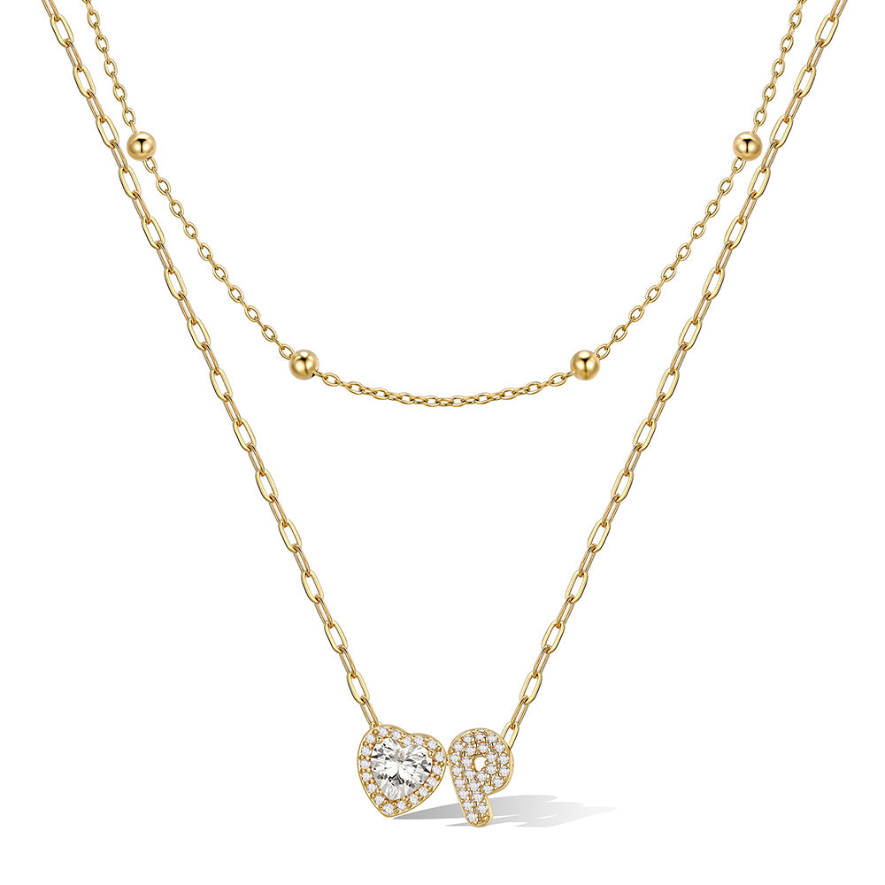 Gold cz bubble initial P necklace with a heart-shaped pendant on a white background