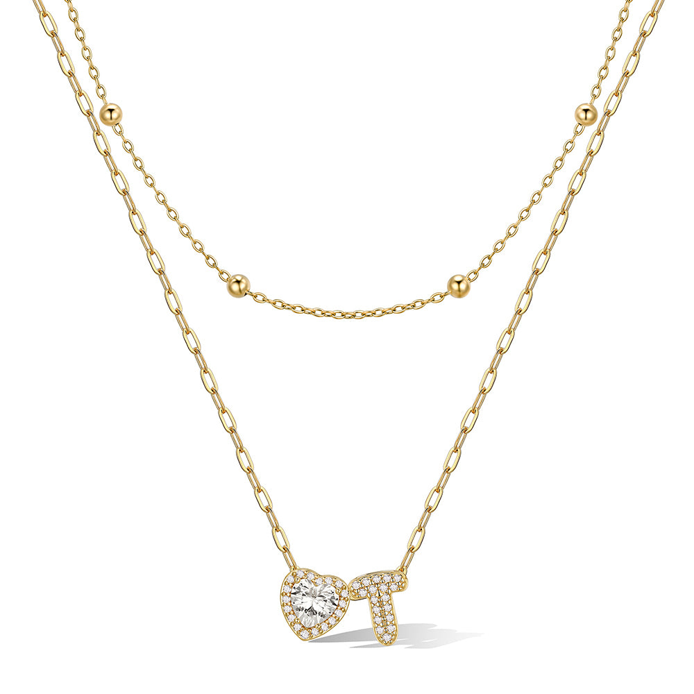 Gold cz bubble initial T necklace with a heart-shaped pendant on a white background