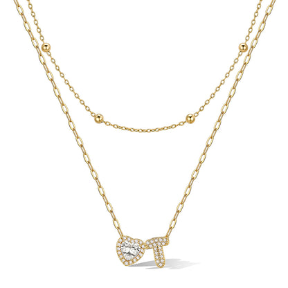 Gold cz bubble initial T necklace with a heart-shaped pendant on a white background