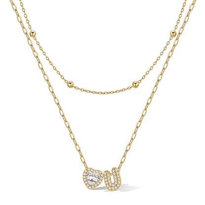 Gold cz bubble initial U necklace with a heart-shaped pendant on a white background