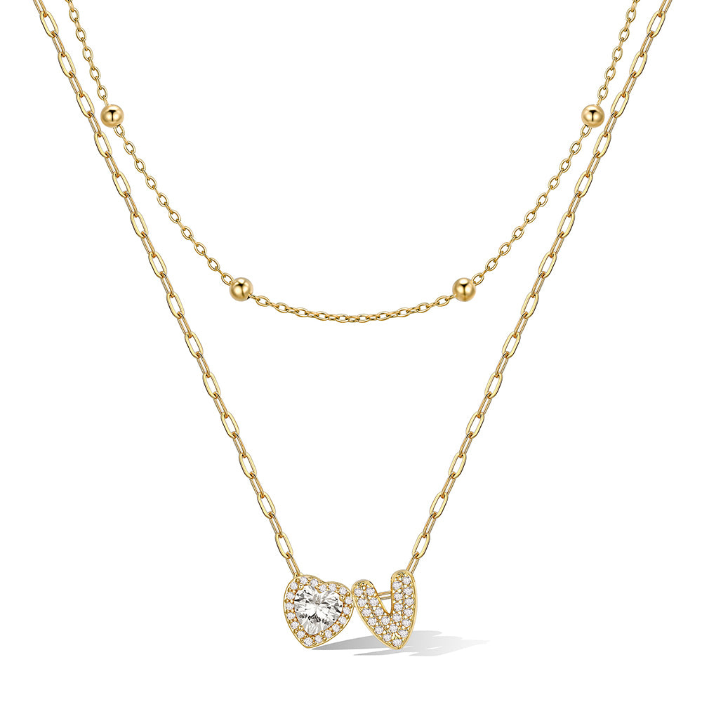Gold cz bubble initial V necklace with a heart-shaped pendant on a white background