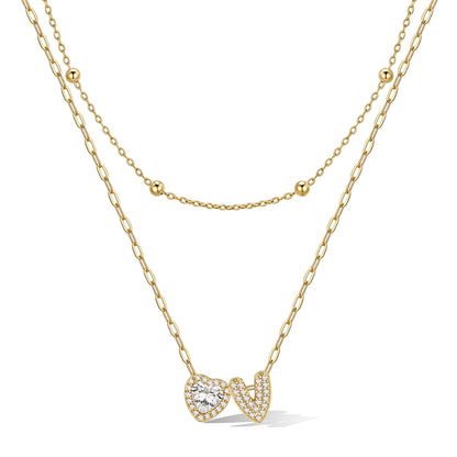 Gold cz bubble initial V necklace with a heart-shaped pendant on a white background