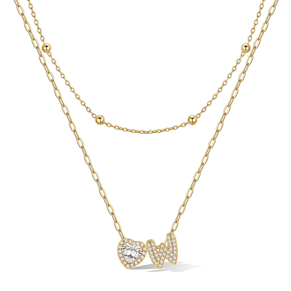 Gold cz bubble initial W necklace with a heart-shaped pendant on a white background