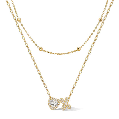 Gold cz bubble initial X necklace with a heart-shaped pendant on a white background