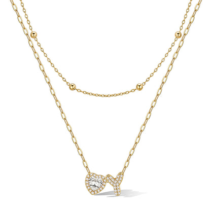 Gold cz bubble initial Y necklace with a heart-shaped pendant on a white background