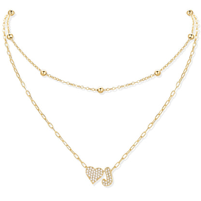 Gold cz initial J necklace with a heart-shaped pendant on a white background