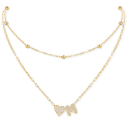 Gold cz initial M necklace with a heart-shaped pendant on a white background