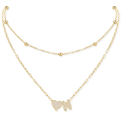 Gold cz initial N necklace with a heart-shaped pendant on a white background