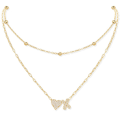 Gold cz initial X necklace with a heart-shaped pendant on a white background