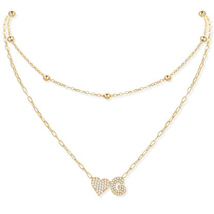 Gold cz initial g necklace with a heart-shaped pendant on a white background