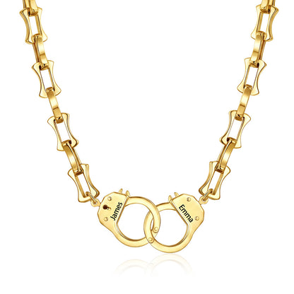 Gold handcuff bamboo link necklace with handcuff pendants engraved with names on a white background