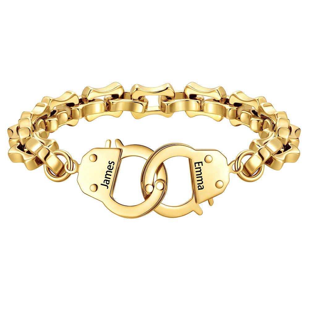 Gold handcuff bracelet with interlocking heart charms engraved with names on a white background
