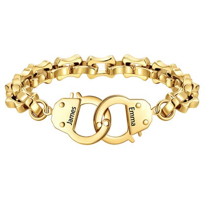 Gold handcuff bracelet with interlocking heart charms engraved with names on a white background