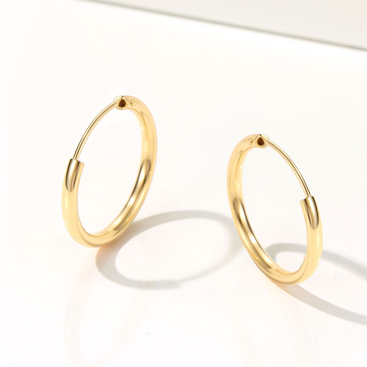 Gold hoop earrings on a white background