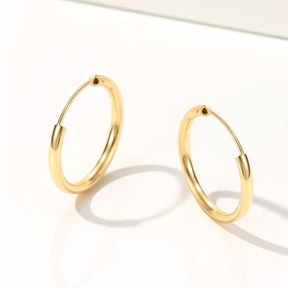 Gold hoop earrings on a white background