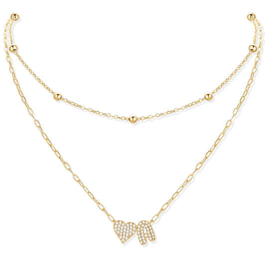 Gold initial A necklace with a heart-shaped pendant on a white background
