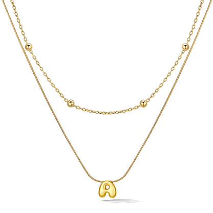 Gold layered initial A necklace, showing measurements and material details.