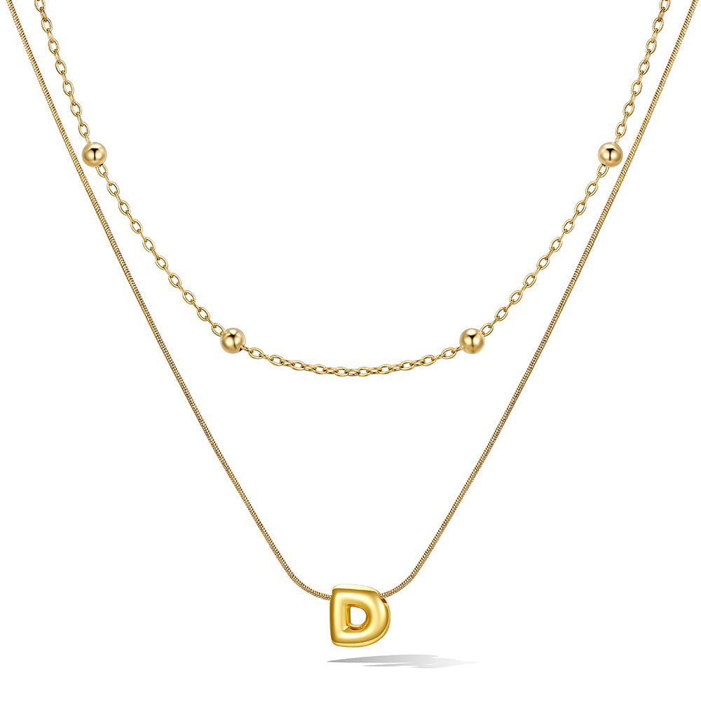 Gold layered initial D necklace, showing measurements and material details.