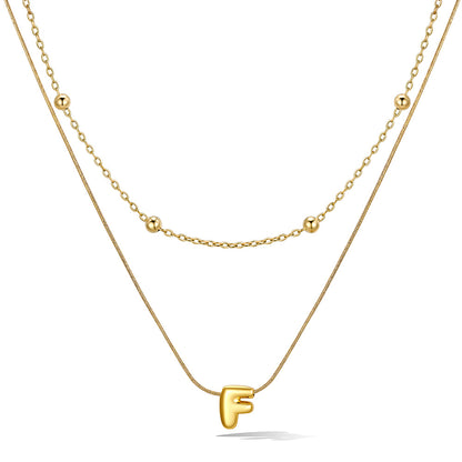 Gold layered initial F necklace, showing measurements and material details.