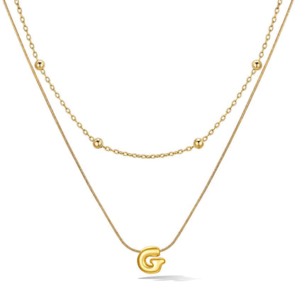Gold layered initial G necklace, showing measurements and material details.