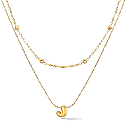 Gold layered initial J necklace, showing measurements and material details.