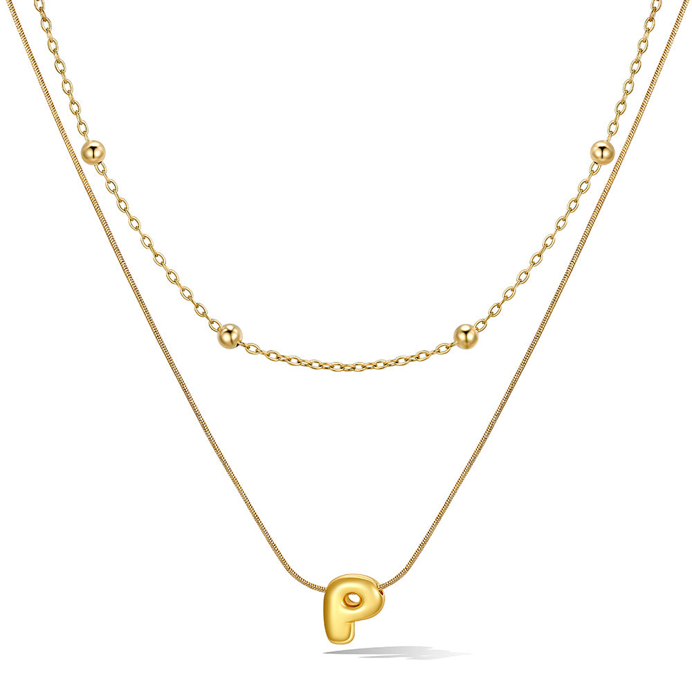 Gold layered initial P necklace with letter 'P' pendant, showing measurements and material details.