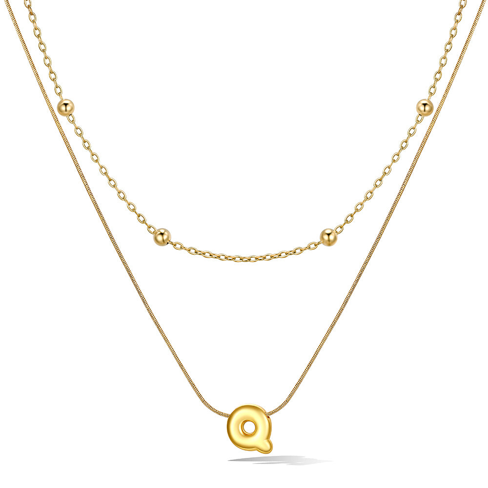 Gold layered initial Q necklace, showing measurements and material details.