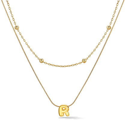 Gold layered initial R necklace with letter 'R' pendant, showing measurements and material details.