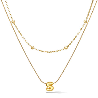 Gold layered initial S necklace with letter 'S' pendant, showing measurements and material details.