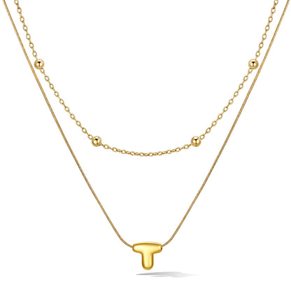 Gold layered initial T necklace with letter 'T' pendant, showing measurements and material details.