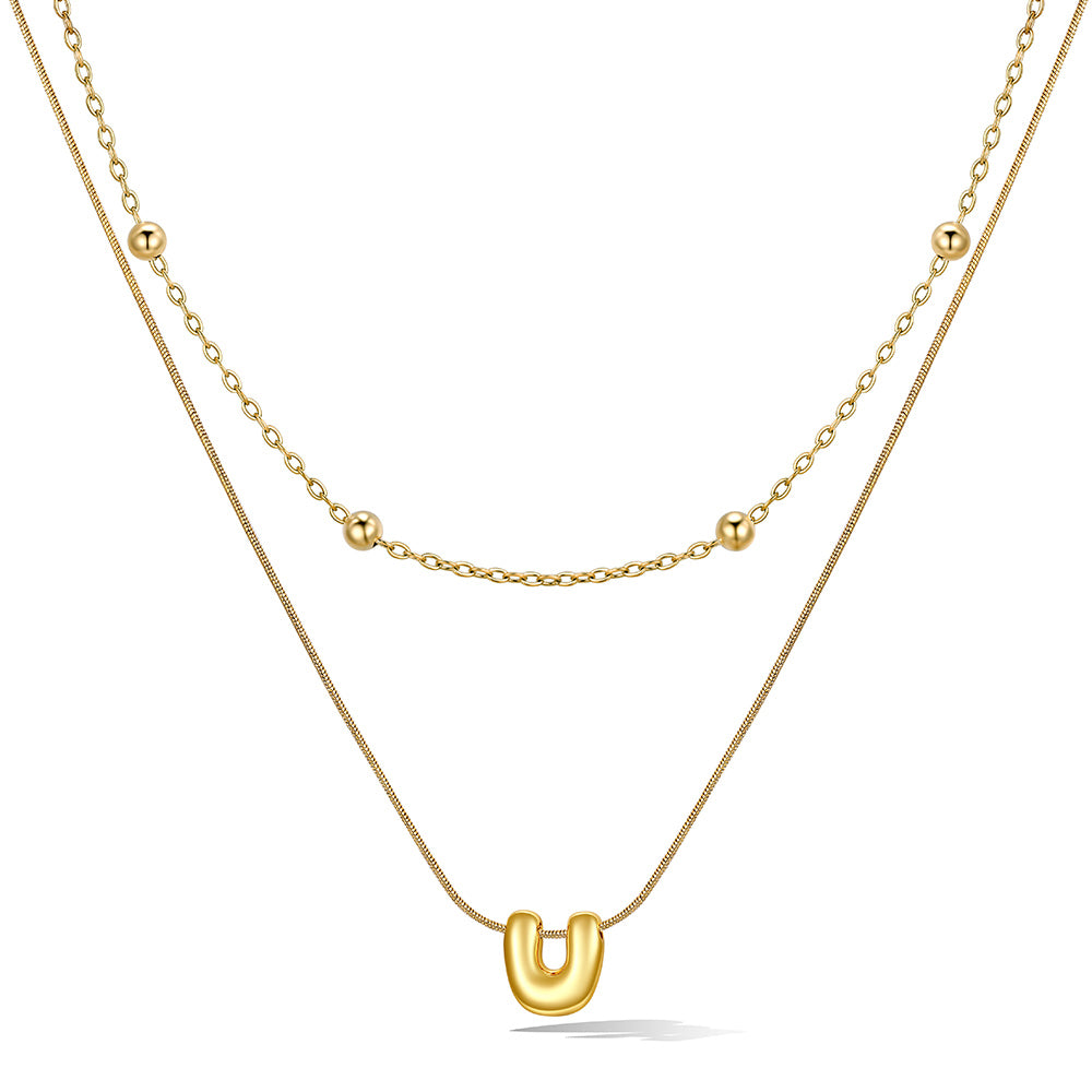 Gold layered initial U necklace with letter 'U' pendant, showing measurements and material details.